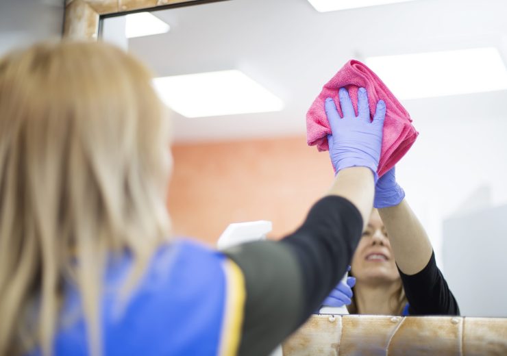 Woman at work, professional maid cleaning in office against virus desease
